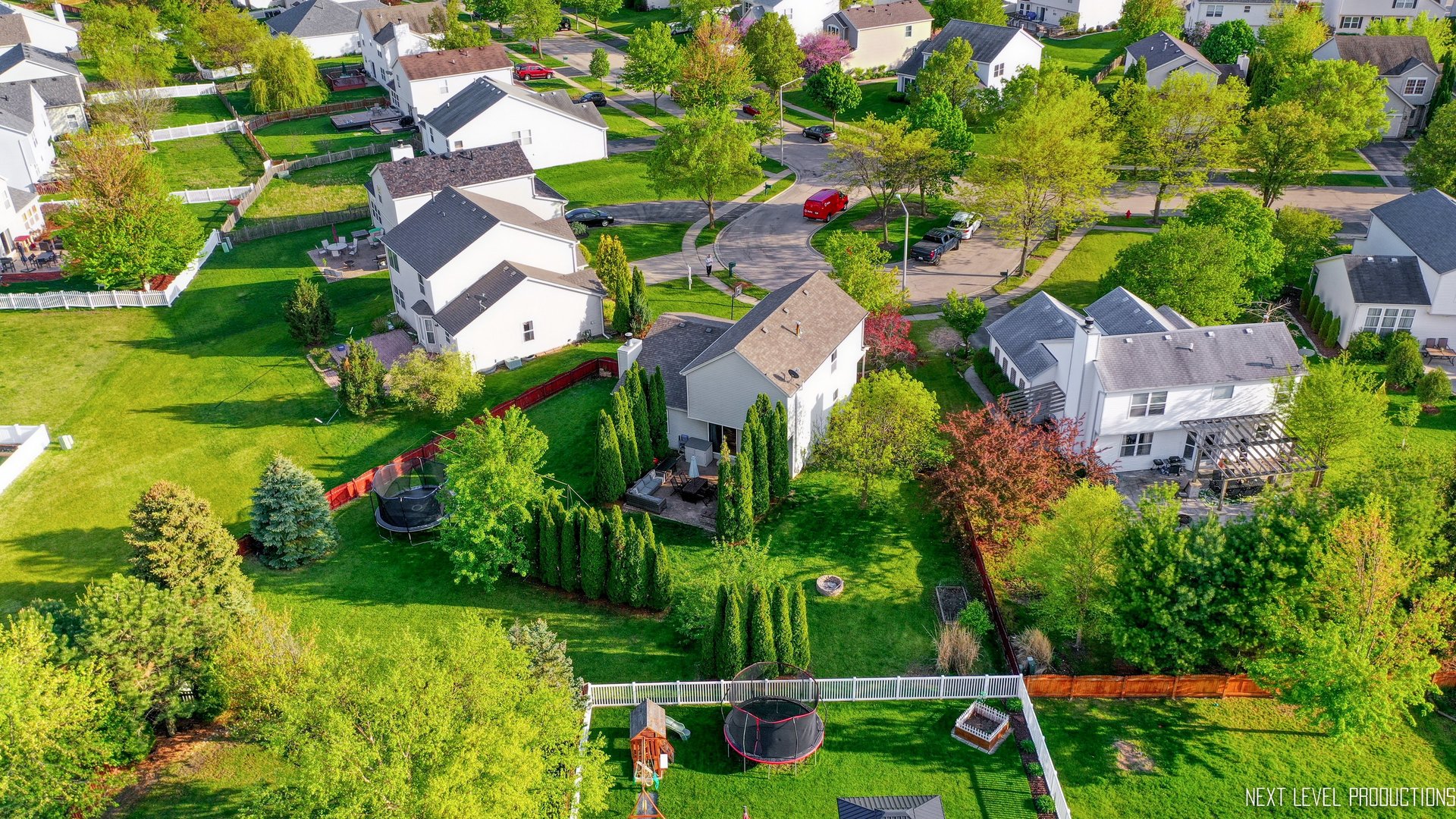 1916 Prairie Ridge Court Plainfield, IL 60586 - Photo 6 of 31 an aerial view of residential houses with outdoor space and trees all around