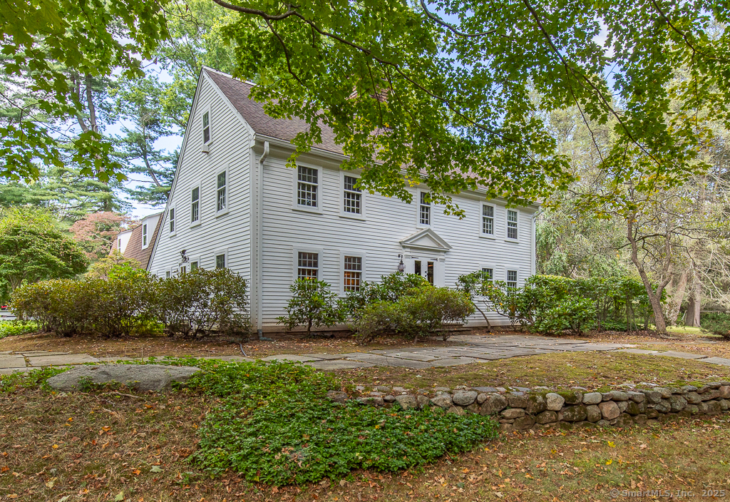 71 Beecher Road Woodbridge, CT 06525 - Photo 14 of 32 a front view of a house with a yard