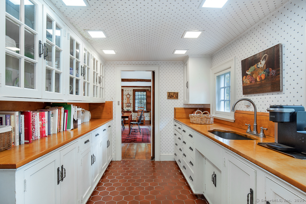 71 Beecher Road Woodbridge, CT 06525 - Photo 18 of 32 a large kitchen with stainless steel appliances granite countertop a lot of cabinets and wooden floor