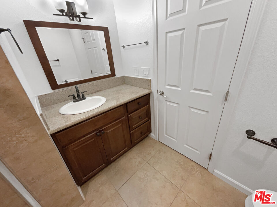 17530 Devonshire Street Northridge, CA 91325 - Photo 13 of 39 a bathroom with a sink vanity and a mirror