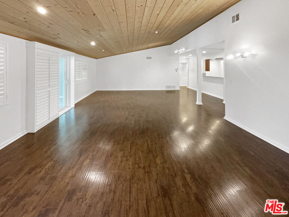 17530 Devonshire Street Northridge, CA 91325 - Photo 14 of 39 a view of an empty room with wooden floor