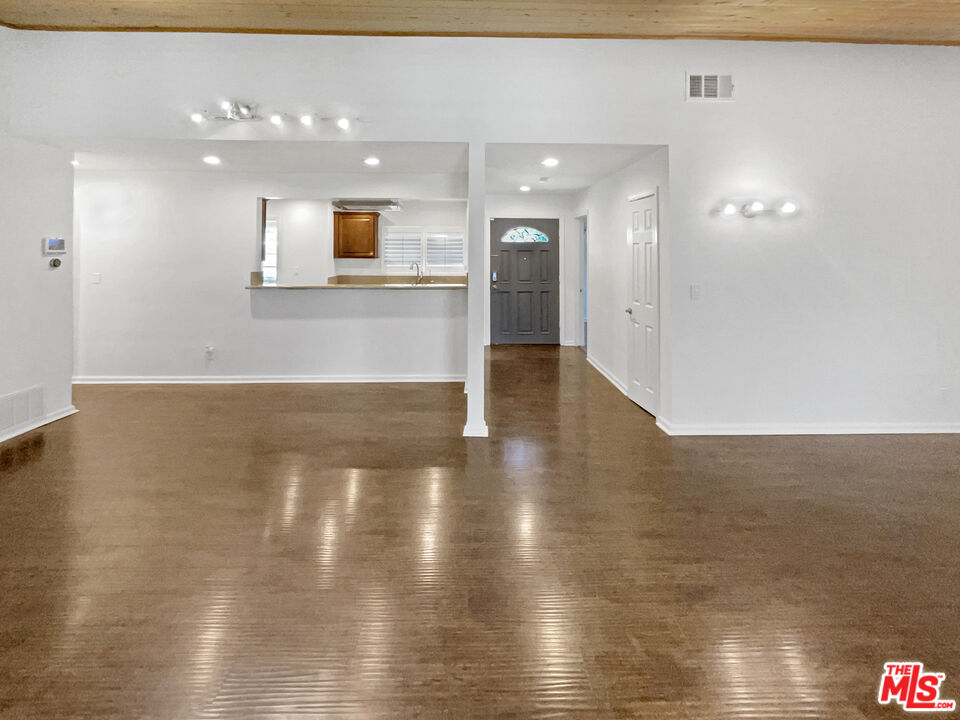 17530 Devonshire Street Northridge, CA 91325 - Photo 15 of 39 a view of a hallway with wooden floor