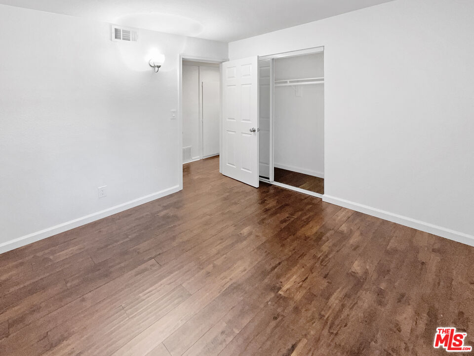 17530 Devonshire Street Northridge, CA 91325 - Photo 20 of 39 a view of an empty room with wooden floor and closet