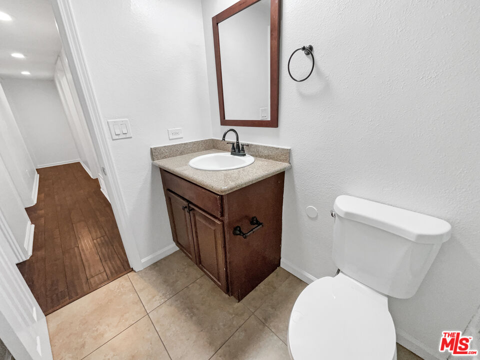17530 Devonshire Street Northridge, CA 91325 - Photo 24 of 39 a bathroom with a toilet sink and mirror