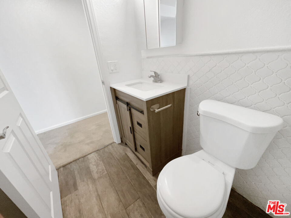 17530 Devonshire Street Northridge, CA 91325 - Photo 26 of 39 a white toilet sitting next to a bathroom sink