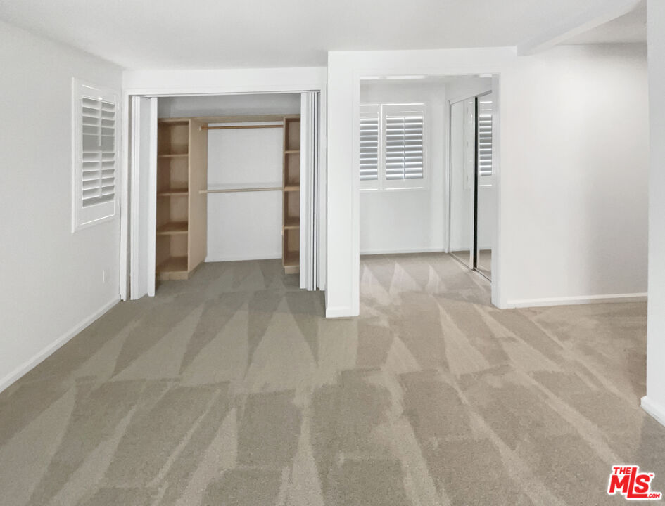 17530 Devonshire Street Northridge, CA 91325 - Photo 28 of 39 an empty room with windows and closet