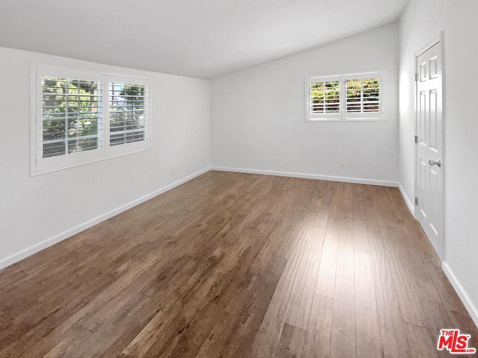 17530 Devonshire Street Northridge, CA 91325 - Photo 3 of 39 a view of a room with wooden floors and window