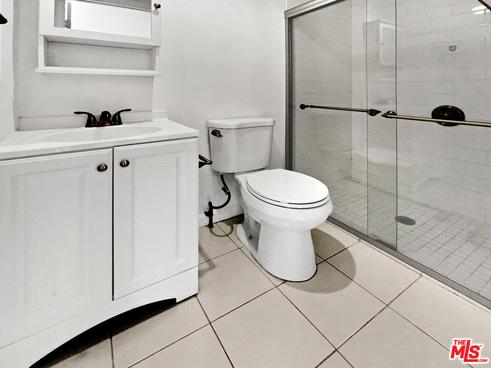 17530 Devonshire Street Northridge, CA 91325 - Photo 33 of 39 a bathroom with a toilet sink and shower