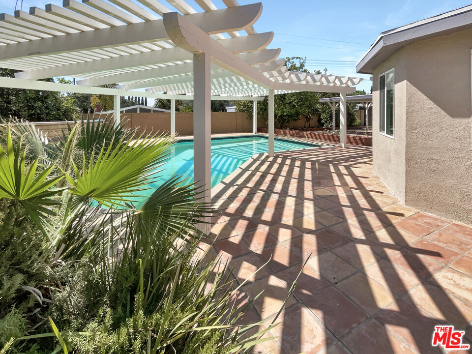 17530 Devonshire Street Northridge, CA 91325 - Photo 34 of 39 a view of a swimming pool with a patio
