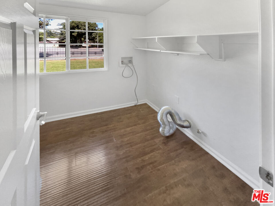 17530 Devonshire Street Northridge, CA 91325 - Photo 37 of 39 a view of water heater room with wooden floor