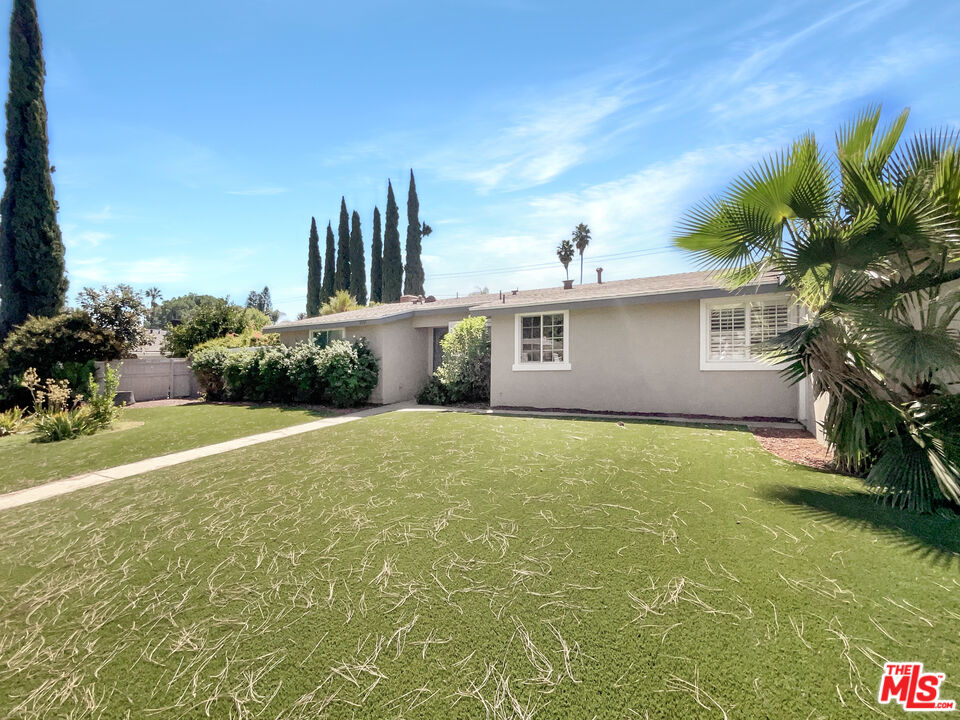 17530 Devonshire Street Northridge, CA 91325 - Photo 7 of 39 a view of a house with a garden and yard