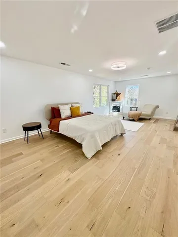 a spacious bedroom with a bed and a table in it