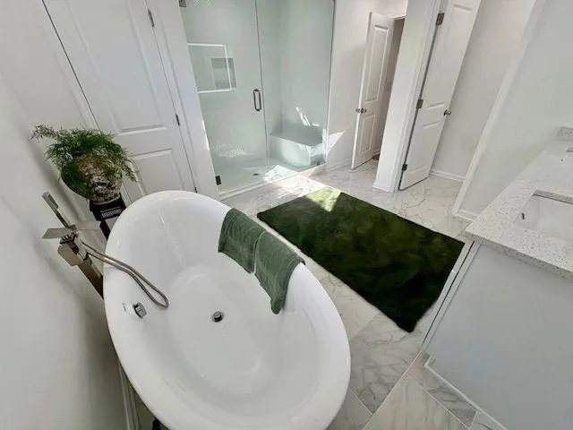 a view of walk in closet with wooden floor