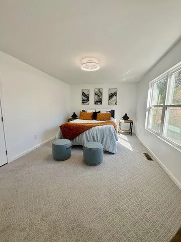 a bedroom with a bed and a couch