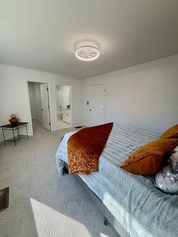 a spacious bathroom with a granite countertop sink a toilet and a bathtub