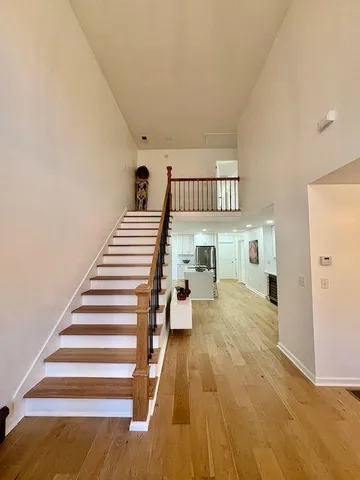 a view of a bedroom with wooden floor