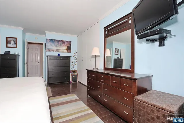 a bedroom with a bed and a dresser