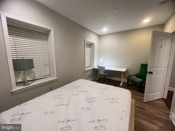 a bed sitting in a kitchen next to a window