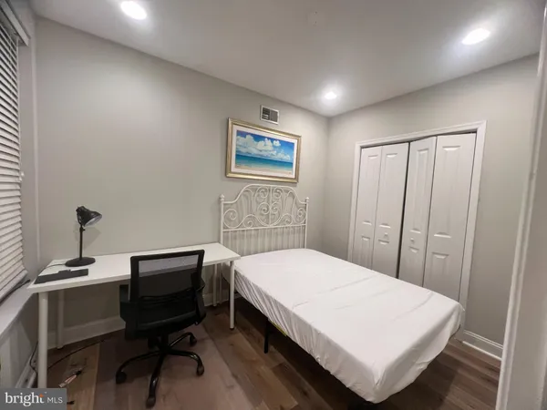 a bedroom with a bed and a desk