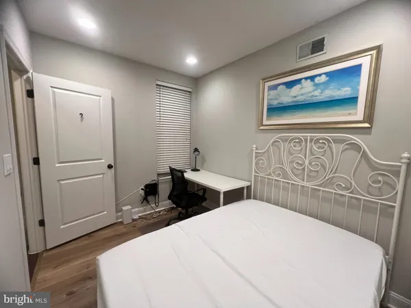 a bedroom with a bed and a table