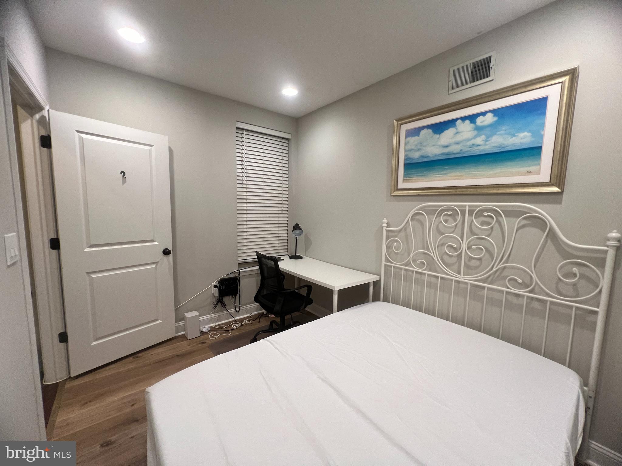 3802 Spring Garden Street Philadelphia, PA 19104 - Photo 14 of 26 a bedroom with a bed and a table