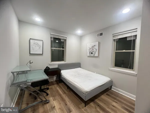 a bedroom with a bed and a table