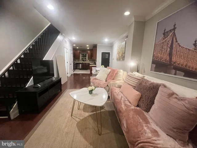 a living room with furniture and wooden floor