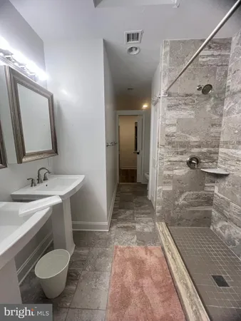a bathroom with a sink and mirror