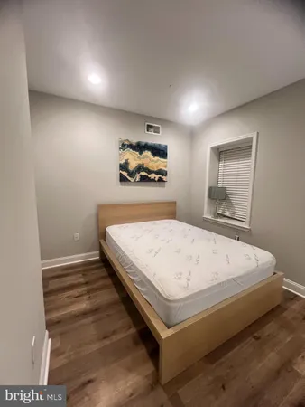 a bed sitting in a bedroom and painting on the wall