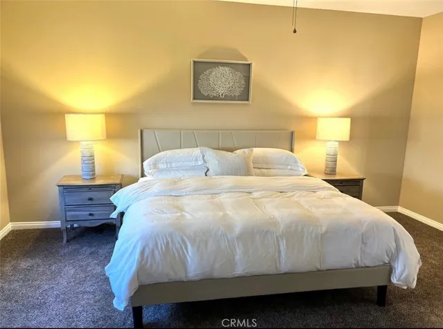 a bedroom with a bed and lamp