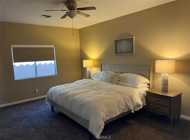 a view of a house with a yard and potted plants
