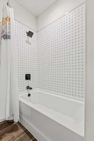 a bathroom with a bathtub and shower