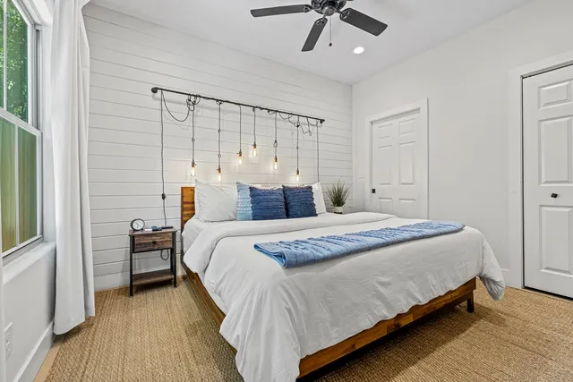 a bedroom with a bed and a chandelier