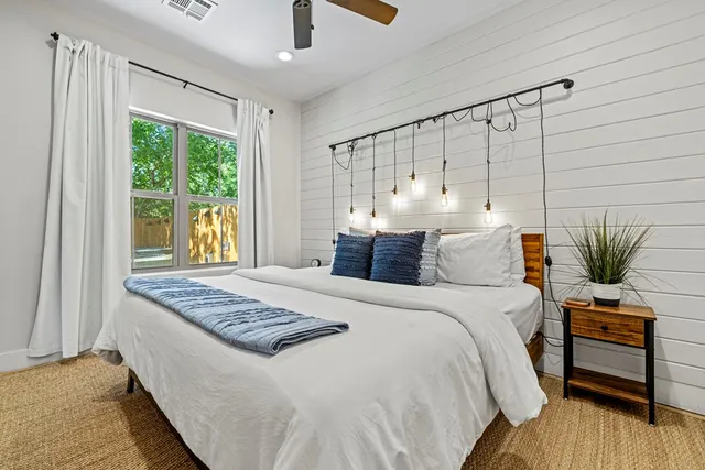 a bedroom with a bed and a window