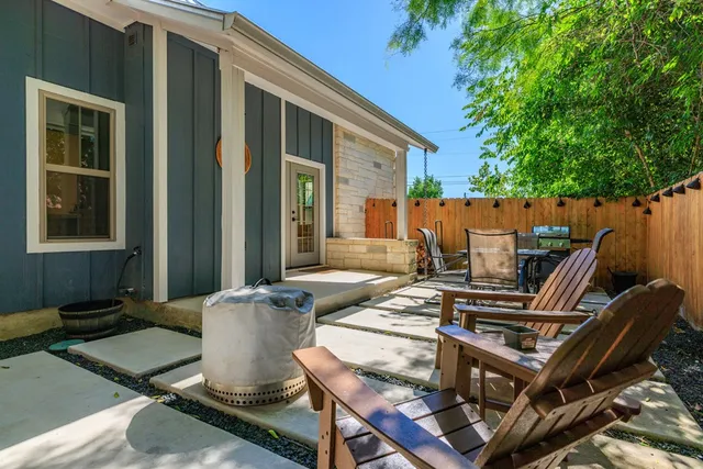 a view of a patio with couches table and chairs and potted plants
