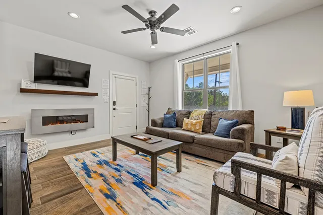 a living room with furniture fireplace and a flat screen tv