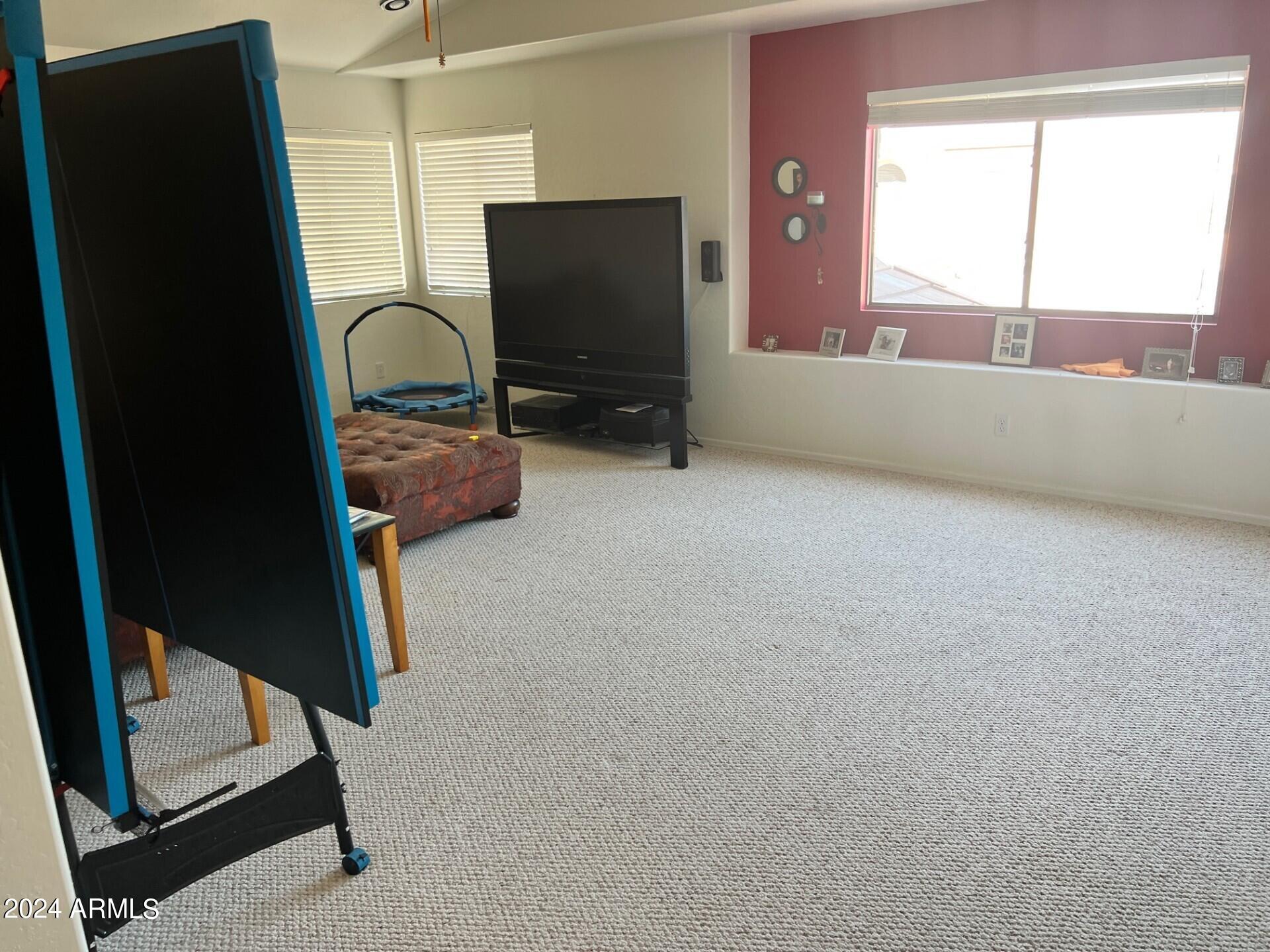 2081 East Desert Inn Drive Chandler, AZ 85249 - Photo 37 of 49 a living room with furniture and a flat screen tv