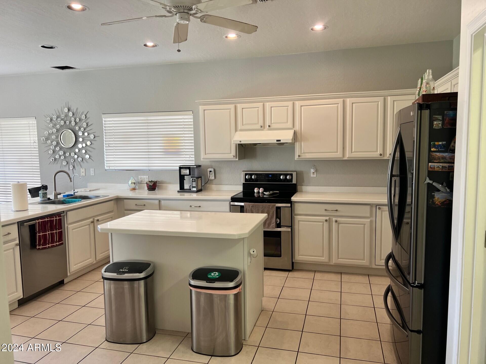 2081 East Desert Inn Drive Chandler, AZ 85249 - Photo 4 of 49 a kitchen with a sink a stove and refrigerator