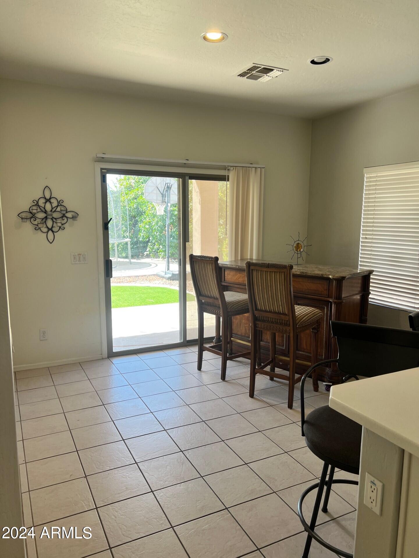 2081 East Desert Inn Drive Chandler, AZ 85249 - Photo 7 of 49 a view of a dining room with furniture window and outside view