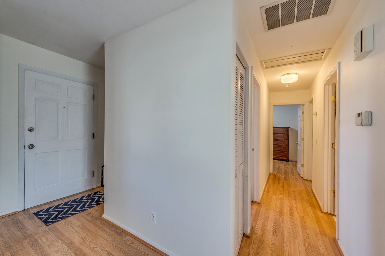 14 Pomeroy Road Montgomery, IL 60538 - Photo 4 of 19 a view of a hallway with wooden floor and a bathroom