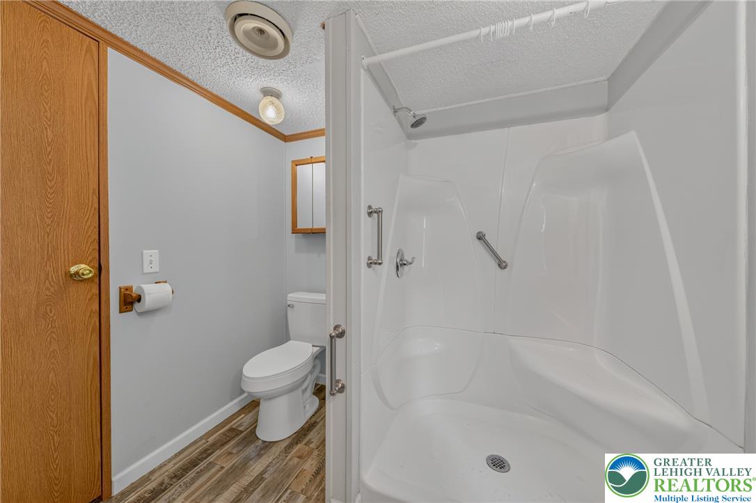 2674 Williams Road Danielsville, PA 18038 - Photo 26 of 31 A well-appointed bathroom featuring a clean, white shower and wood-look flooring.