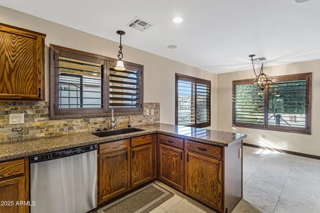 a kitchen with a sink stove and cabinets