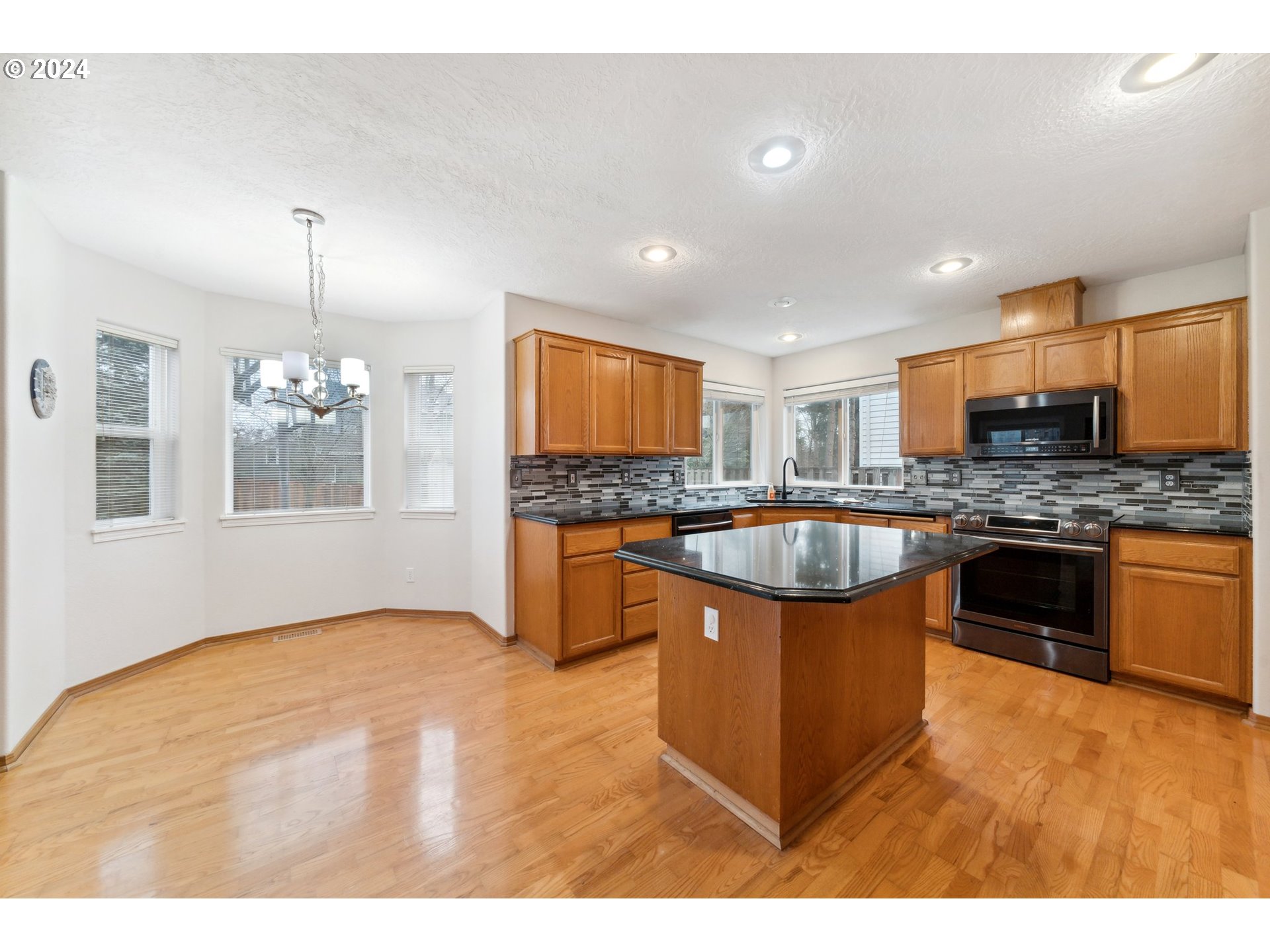 527 Southwest 27th Way Troutdale, OR 97060 - Photo 11 of 41 a kitchen with stainless steel appliances granite countertop a sink stove and refrigerator