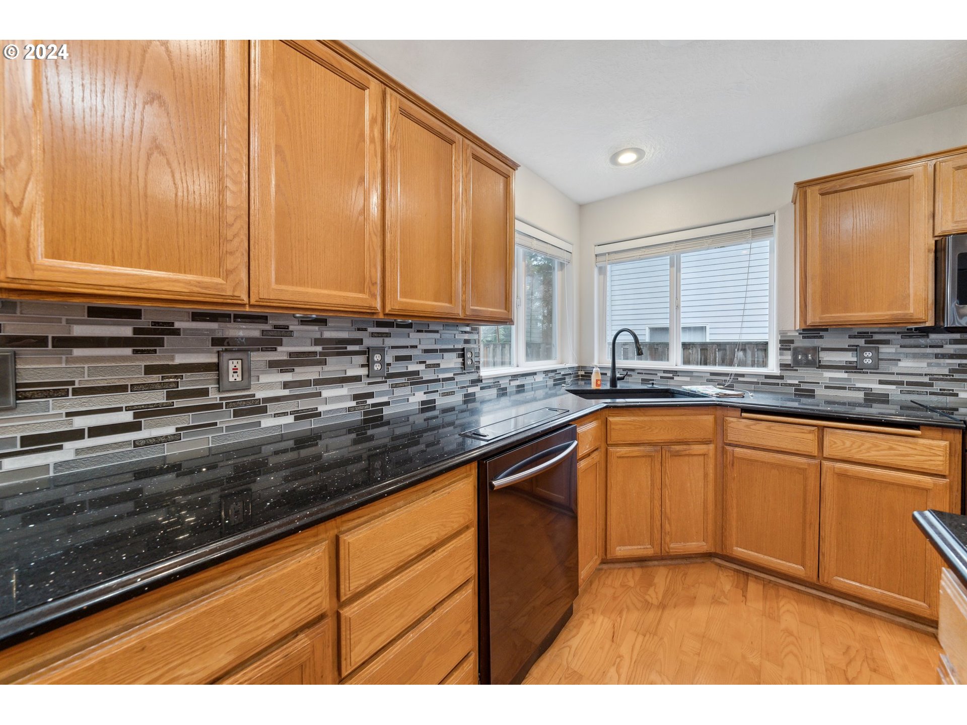 527 Southwest 27th Way Troutdale, OR 97060 - Photo 14 of 41 a kitchen with stainless steel appliances granite countertop a sink stove and cabinets