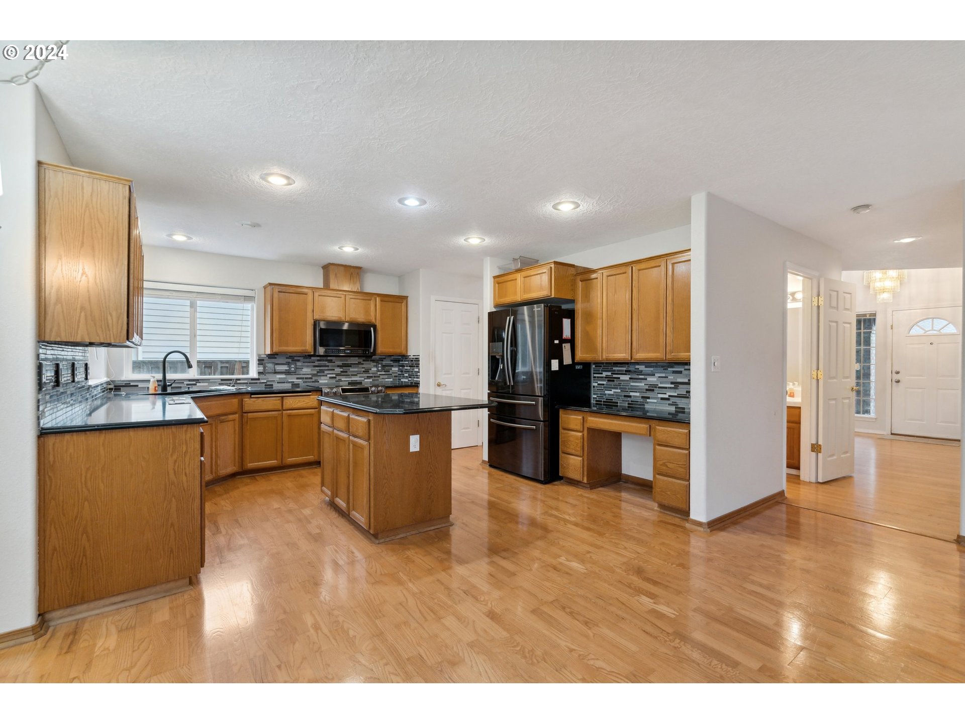 527 Southwest 27th Way Troutdale, OR 97060 - Photo 17 of 41 a large kitchen with stainless steel appliances kitchen island granite countertop a large counter top stainless steel appliances and cabinets