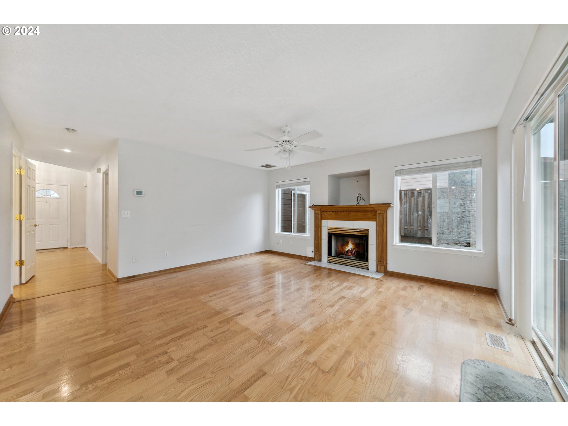 527 Southwest 27th Way Troutdale, OR 97060 - Photo 18 of 41 a view of an empty room with a fireplace and window