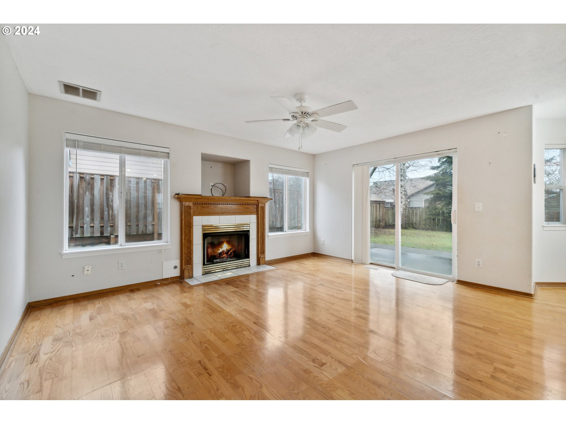 527 Southwest 27th Way Troutdale, OR 97060 - Photo 19 of 41 a view of an empty room with a fireplace and a window