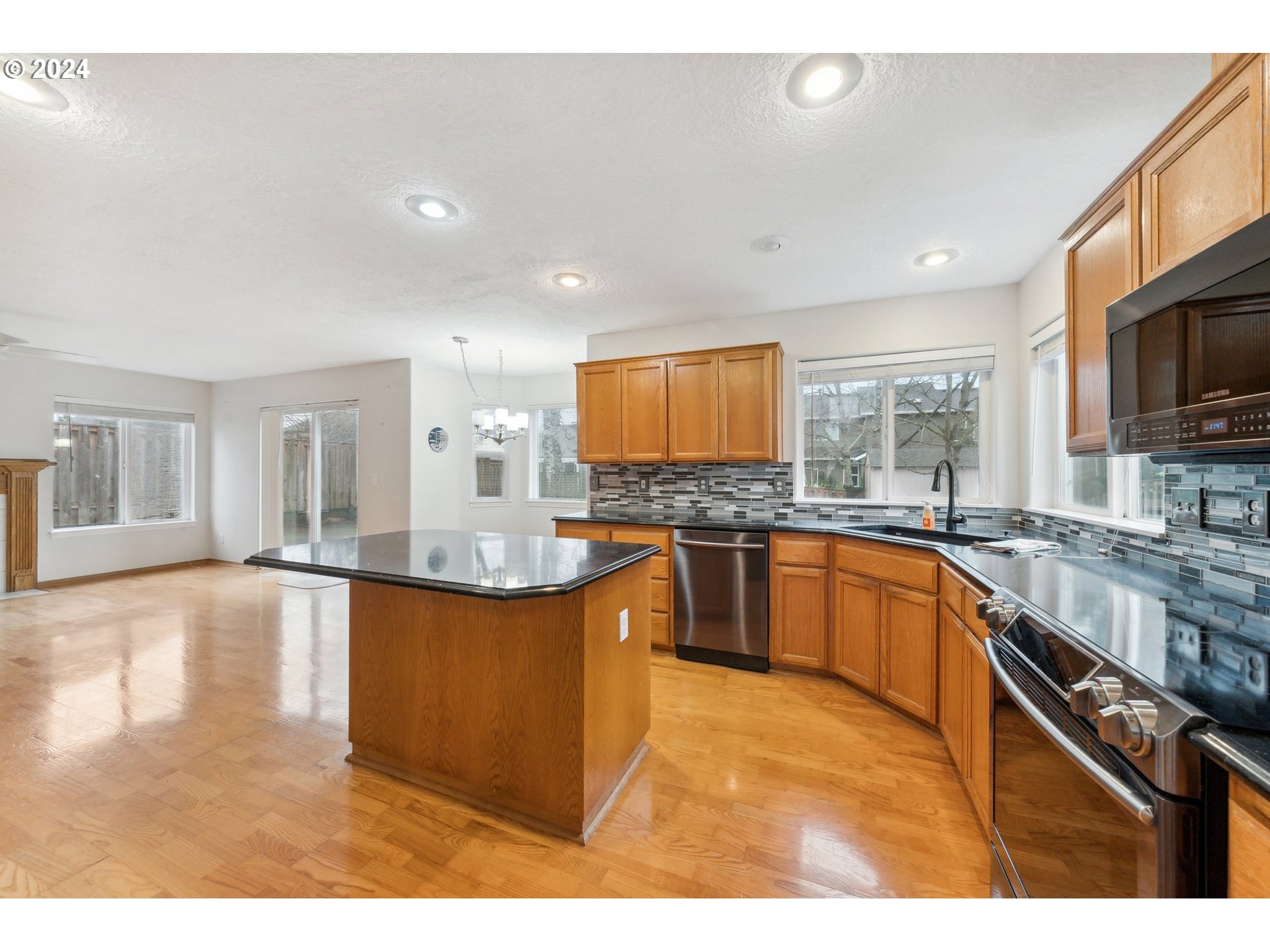 527 Southwest 27th Way Troutdale, OR 97060 - Photo 10 of 41 a large kitchen with granite countertop a large counter top cabinets and stainless steel appliances