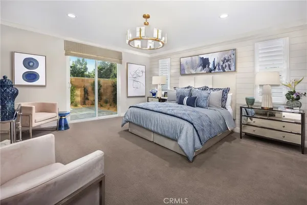 a spacious bedroom with a bed a couch and a window