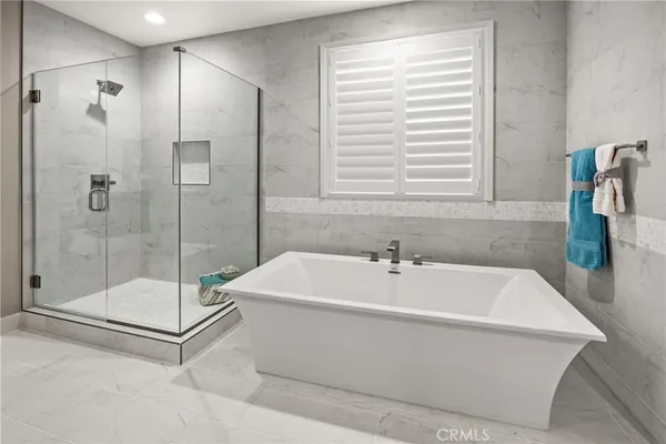 a bathroom with a bathtub and a shower